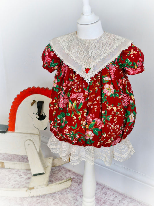 2-3 years. Burgundy floral vintage dress from Beaux Age with cream lace bib and long hem.