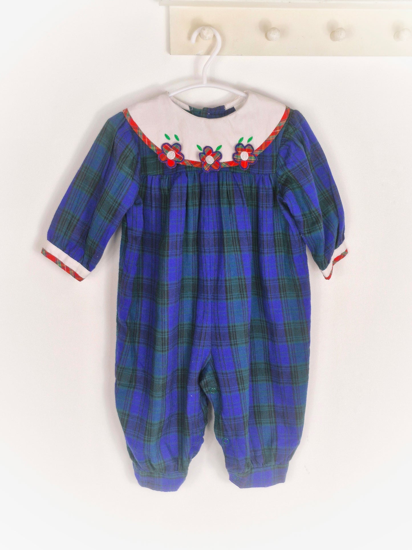 6-12 months. Navy and green tartan romper with white bib, red tartan flowers and trim