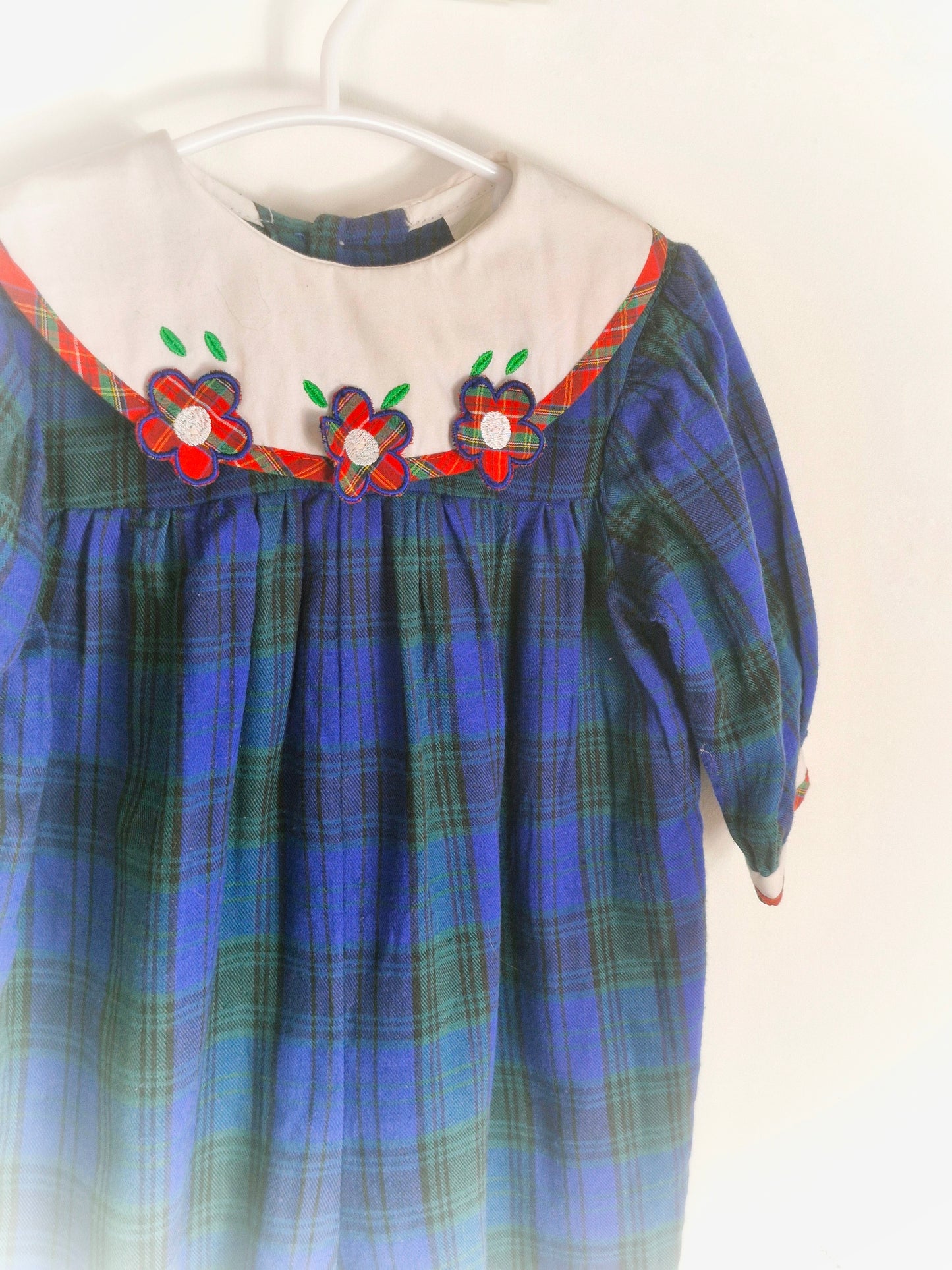 6-12 months. Navy and green tartan romper with white bib, red tartan flowers and trim