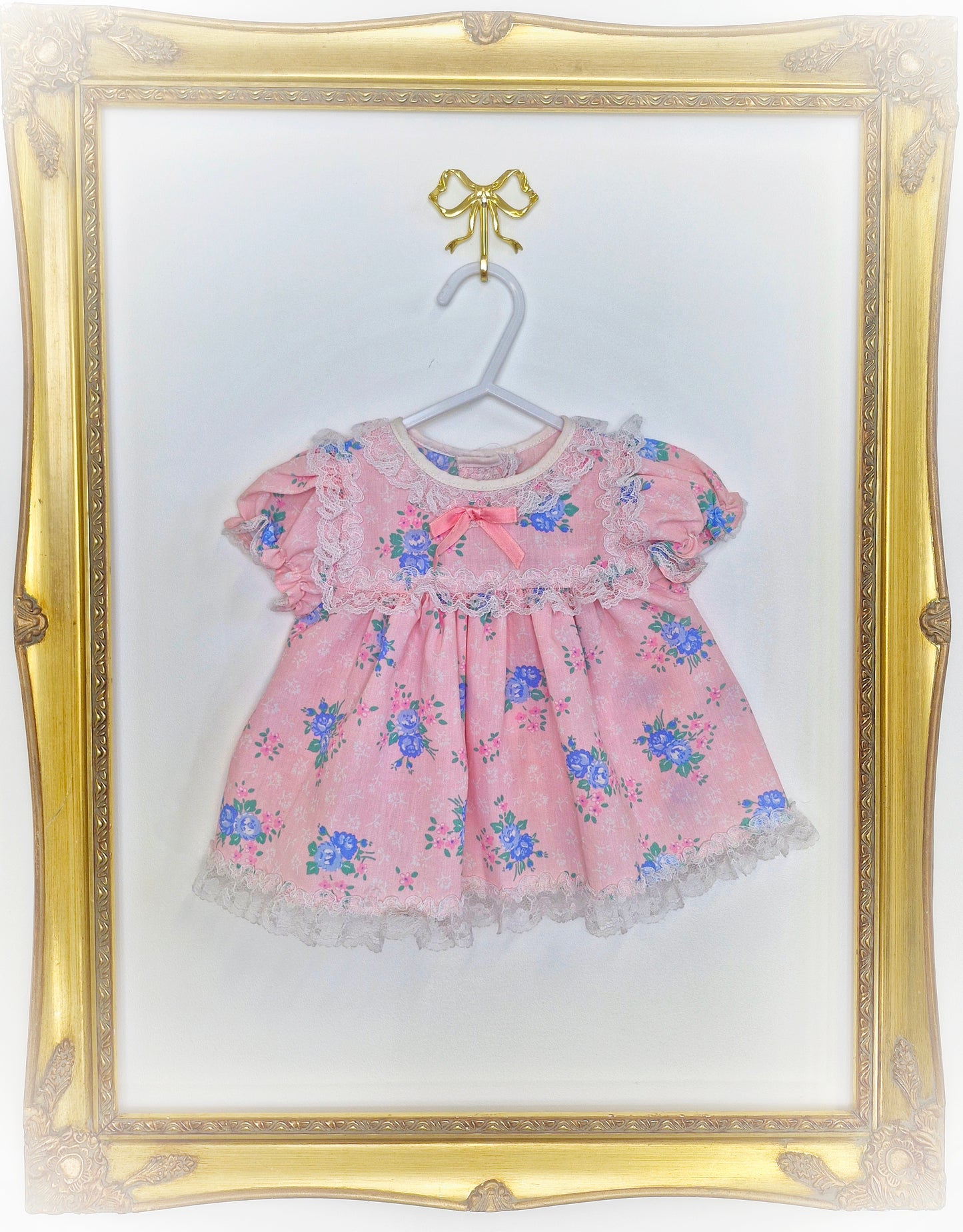 3-6 months. Light pink vintage dress with blue floral print and white lace details
