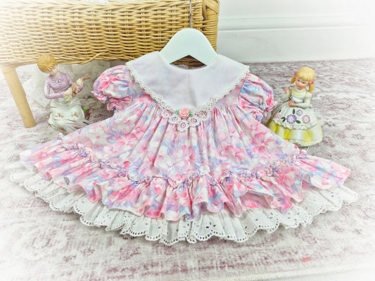 6-12 months. Vintage Little Gems. Pastel floral dress with white bib and pink rosette