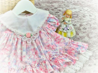 6-12 months. Vintage Little Gems. Pastel floral dress with white bib and pink rosette