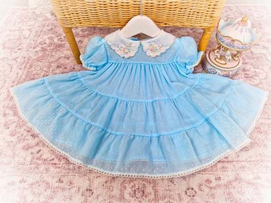 12 months. Pale blue vintage dress with white collar, embroidered with rainbow details