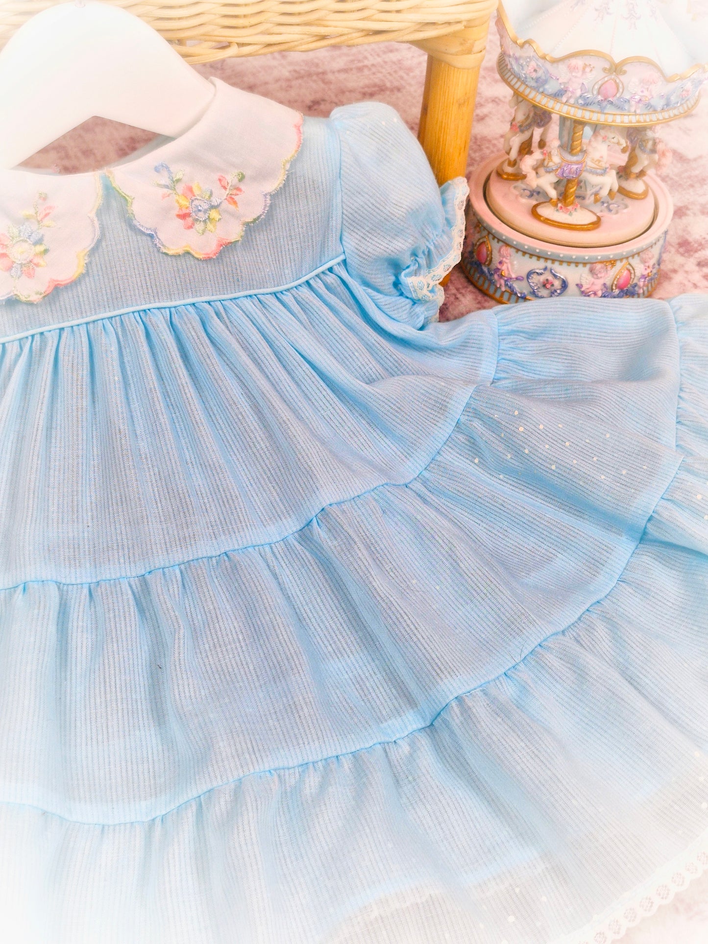 12 months. Pale blue vintage dress with white collar, embroidered with rainbow details