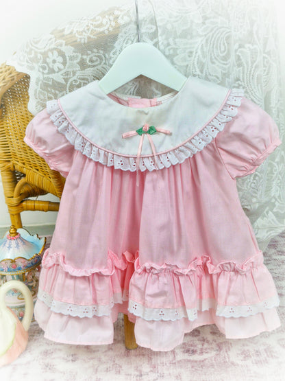 12-18 months. Pink vintage dress from Rose Cottage, white frilly bib and layered hem