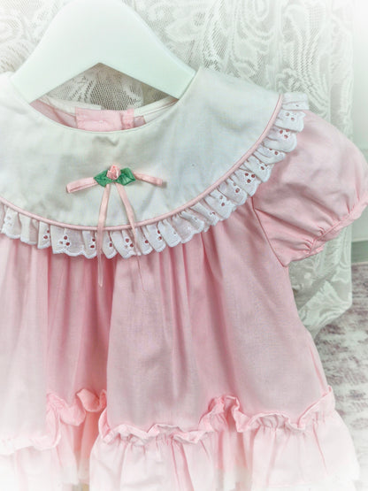 12-18 months. Pink vintage dress from Rose Cottage, white frilly bib and layered hem