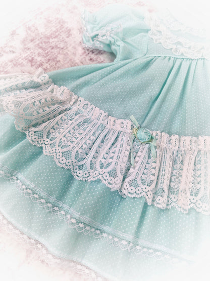9-12 months. Vintage Petit Jouet, mint dress with white lace and rosettes