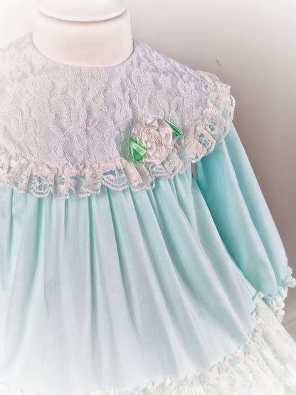 2 years. Mint vintage Alexis with white lace and frills. Lacey bib with dainty flower and long sleeves
