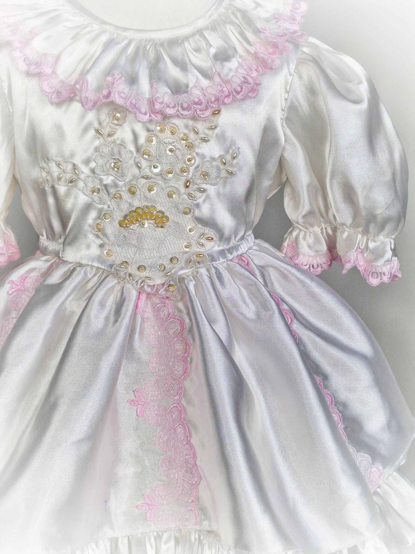 3 years. White satin vintage layered dress with pink lace and puff sleeves.