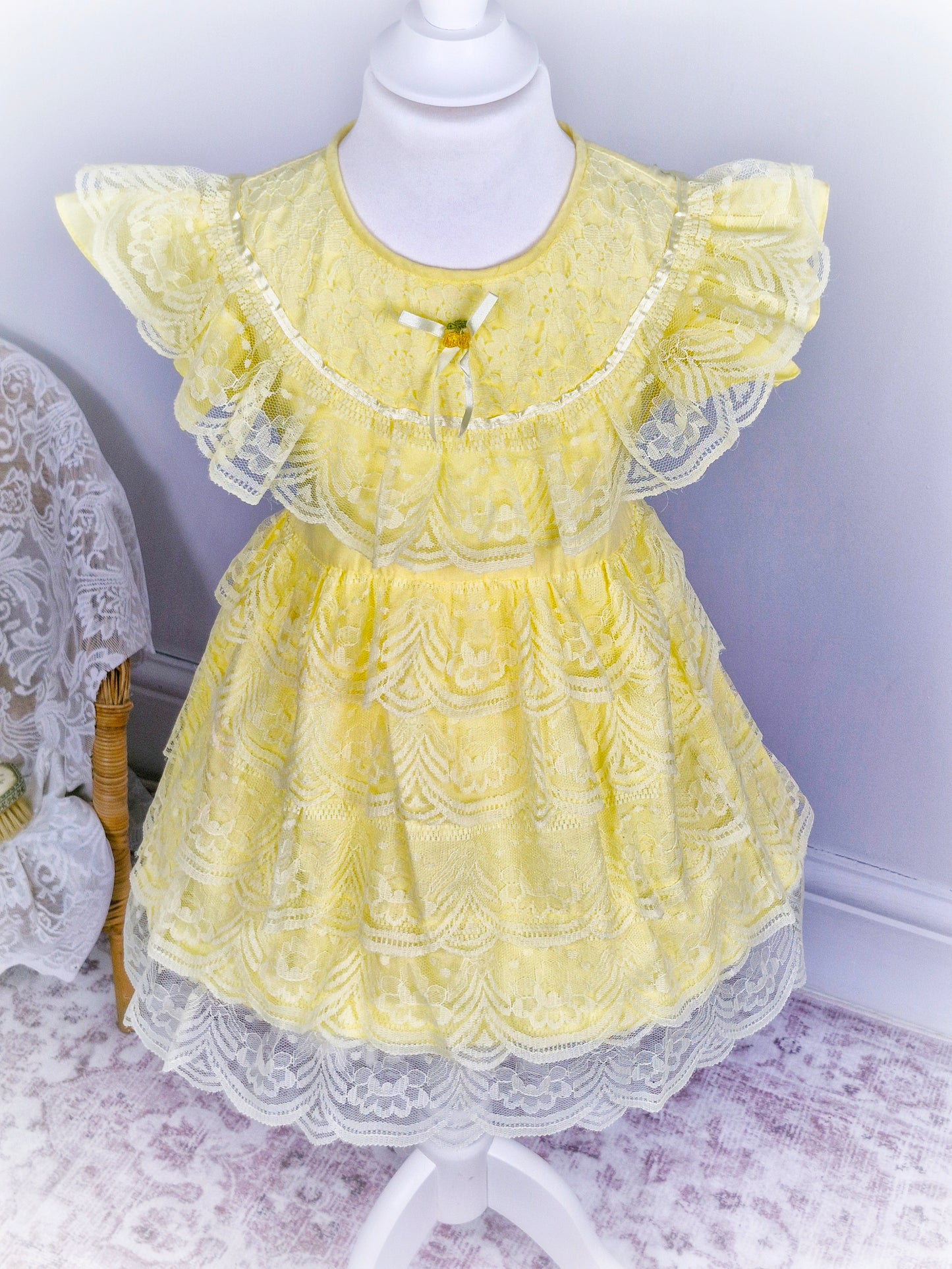 3-4 years. Lemon dress with layered lace ruffles, flutter sleeves, ribbon and rosette