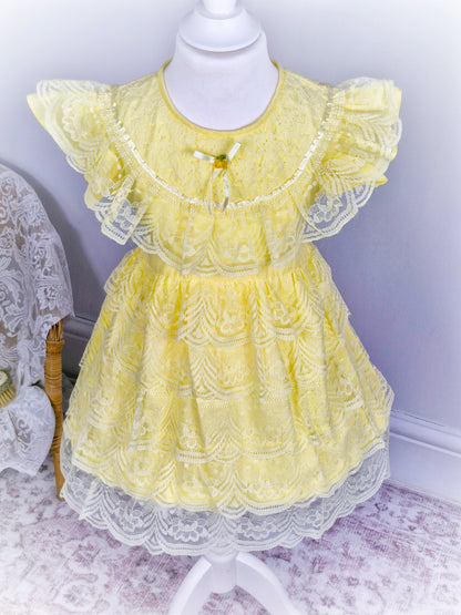 3-4 years. Lemon dress with layered lace ruffles, flutter sleeves, ribbon and rosette