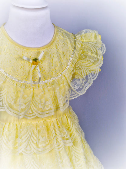 3-4 years. Lemon dress with layered lace ruffles, flutter sleeves, ribbon and rosette