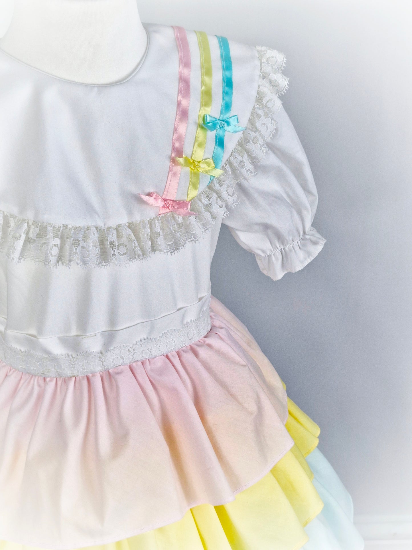 5 years. Vintage Kandy Ann, white dress with pastel coloured layers and ribbons