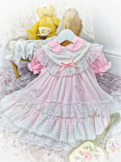 18 months - 2 years. Pink vintage dress with puff sleeves and white apron from Kotton Kandi with lace layers and pink ribbon