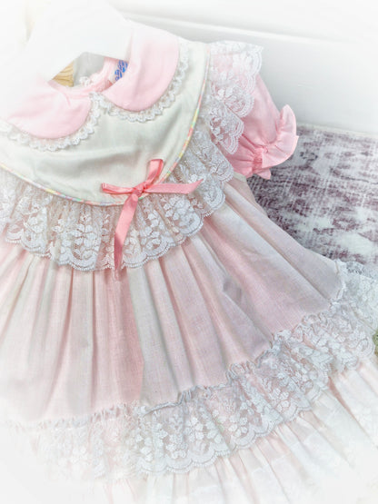 18 months - 2 years. Pink vintage dress with puff sleeves and white apron from Kotton Kandi with lace layers and pink ribbon