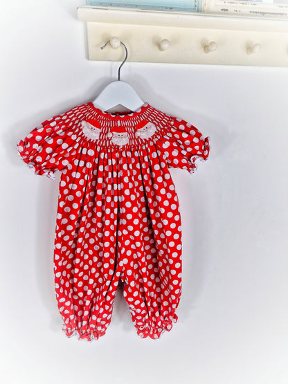 6-12 months. Red and white polka dot smock romper with embroidered santas