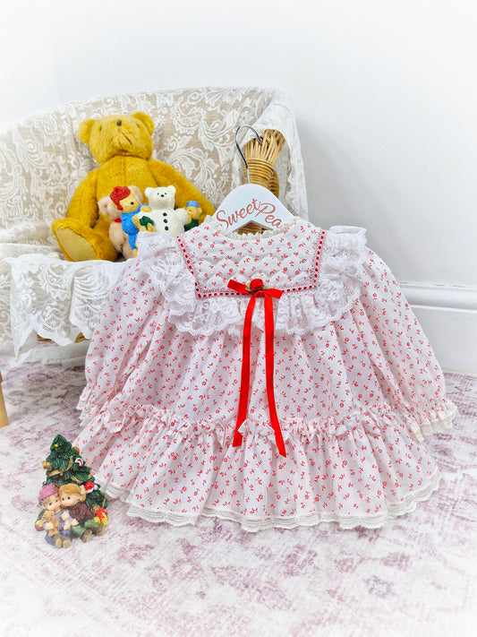 6-12 months. White vintage Bryan with red floral print and ribbon, white lace