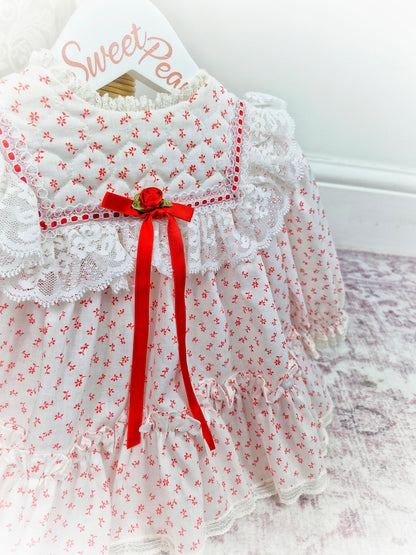 6-12 months. White vintage Bryan with red floral print and ribbon, white lace