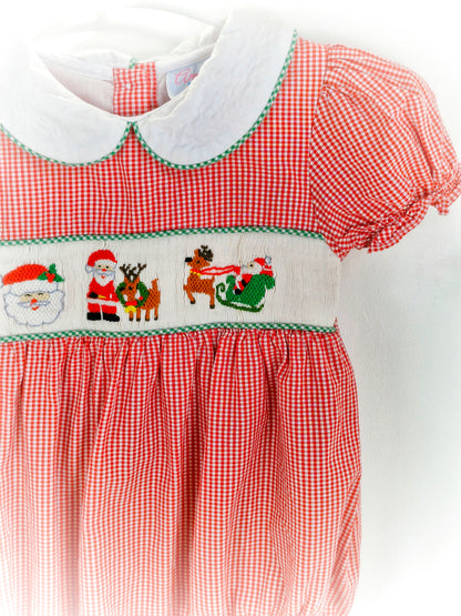 12-18 months. Red and white gingham smocked romper with embroidered santas, white Peter Pan collar and puff sleeves