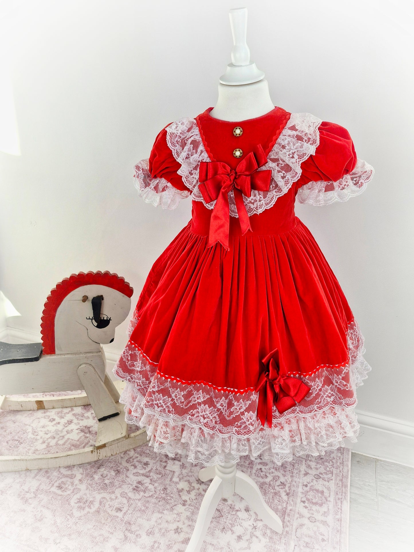 5-6 years. Red velvet vintage dress, lace hem and trim. Faux pearl buttons and red bows.