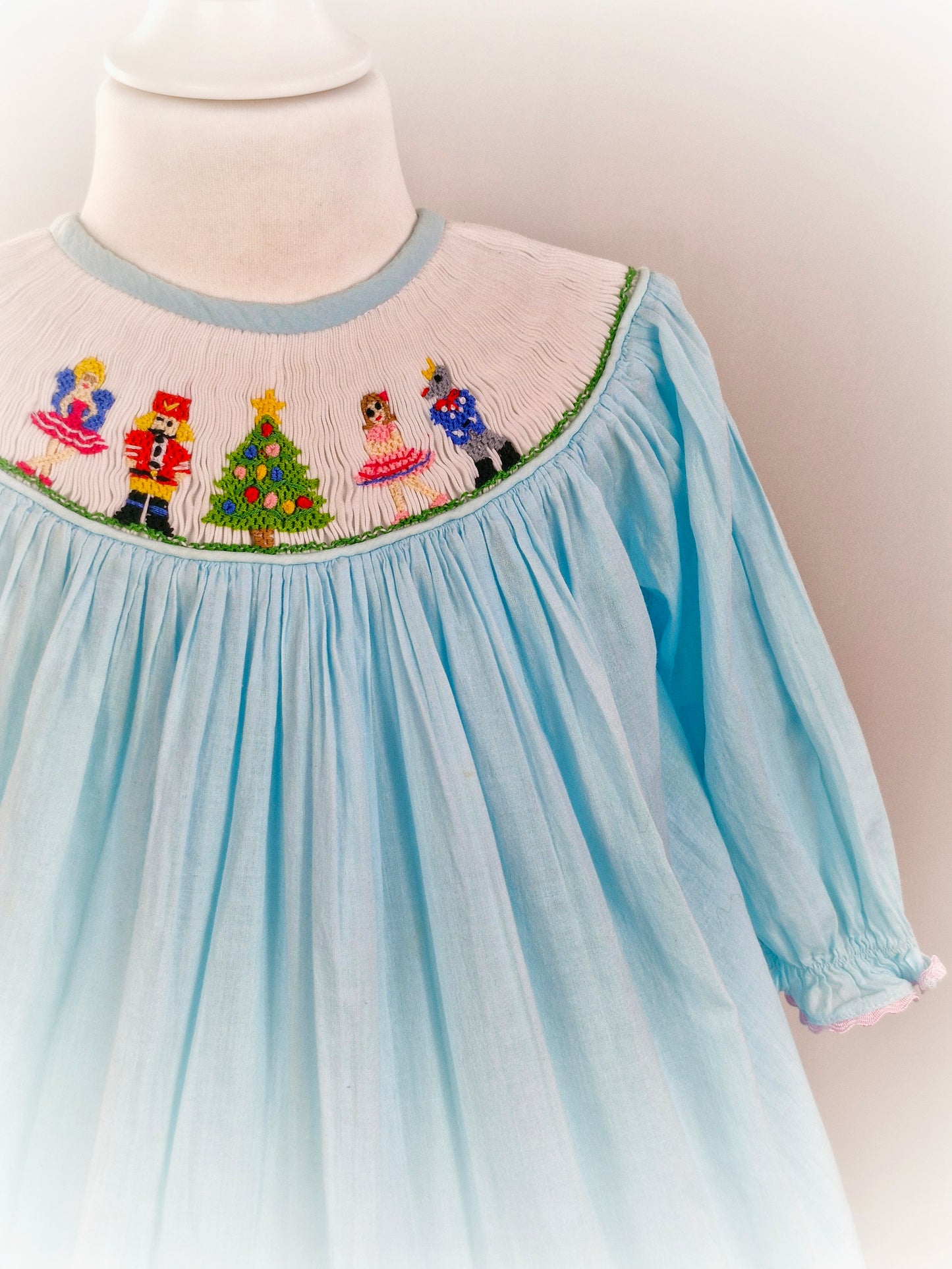 2-3 years. Pale blue smock dress with nutcracker and ballerina embroidered