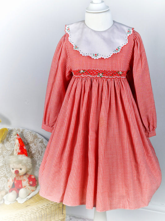 5-6 years. Red and white gingham vintage dress with smock waist and white embroidered bib.