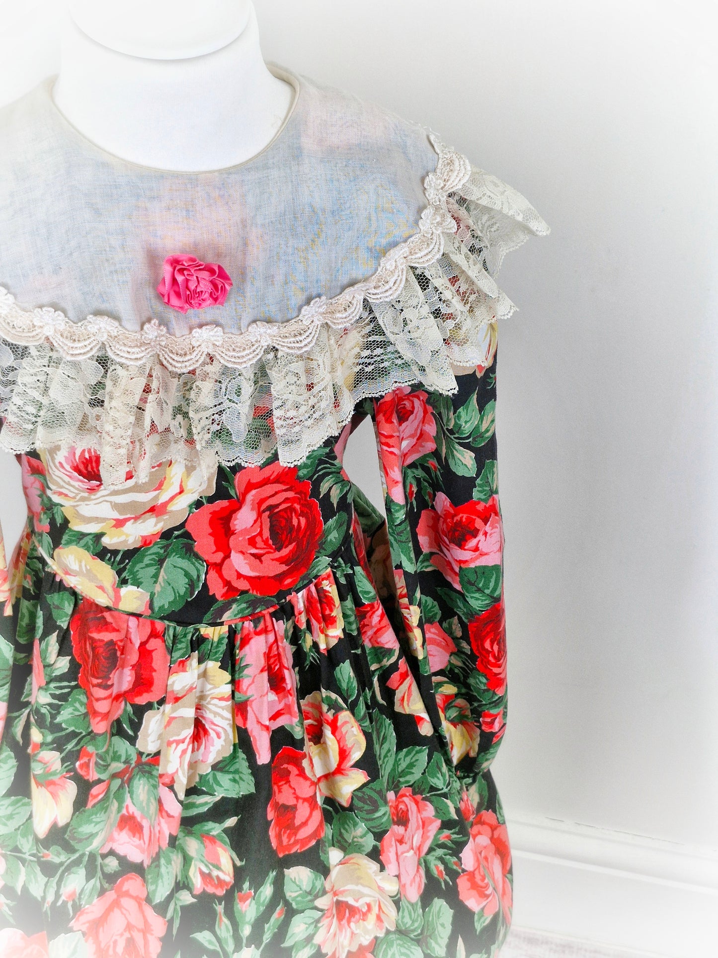 6-7 years. Vintage Peaches n' Cream dress with large floral print, cream bib trimmed with lace