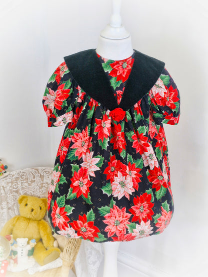 3 years. Black vintage dress by L.J Girls with red and pink poinsettia print and green leaves.