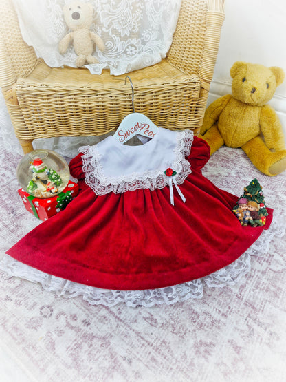 6-9 months. Red velour vintage Bryan dress with white frill bib and red rosette