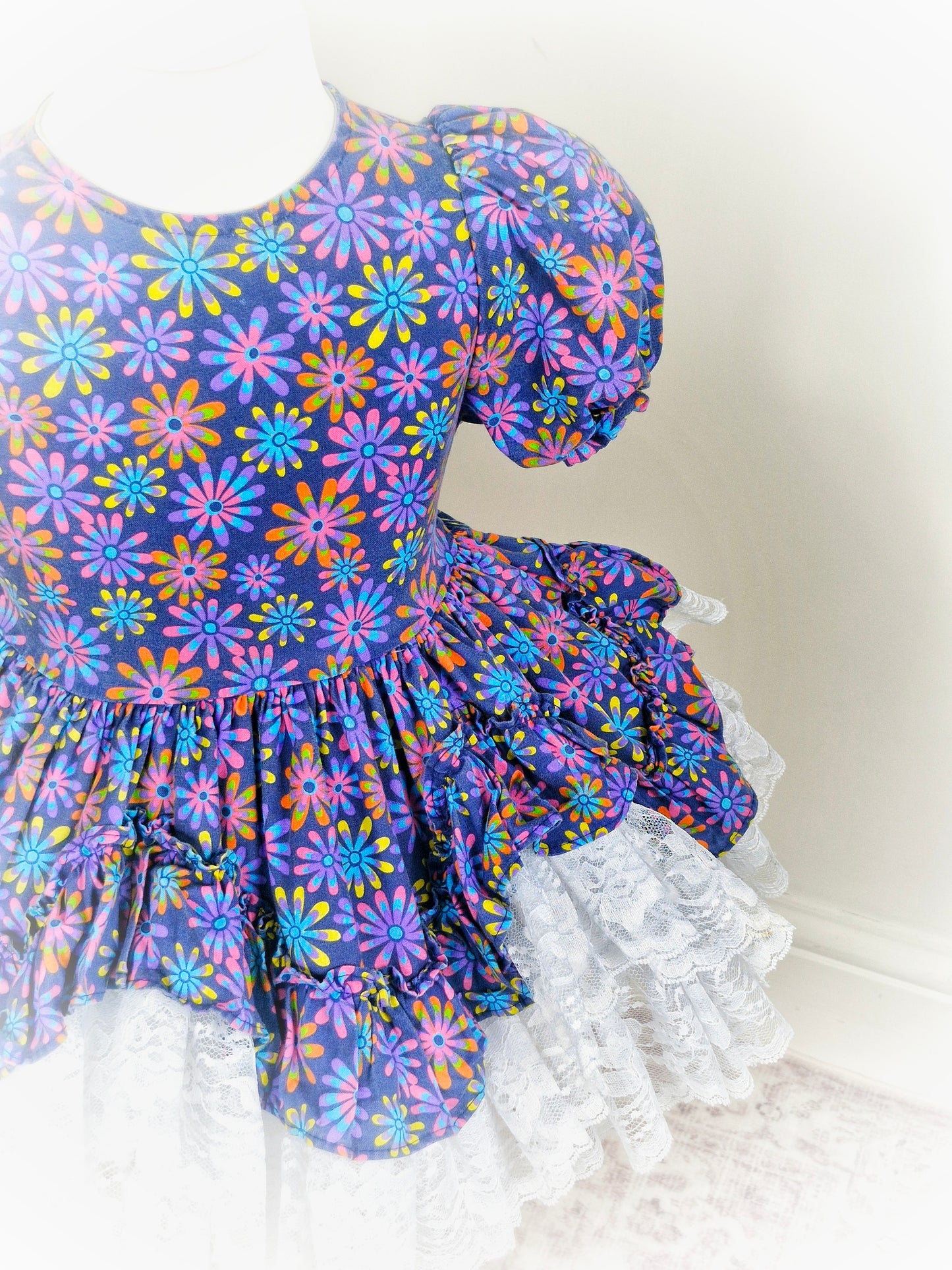 3 years. Navy blue floral Lid'l Dolly with white lace ruffles and puff sleeves