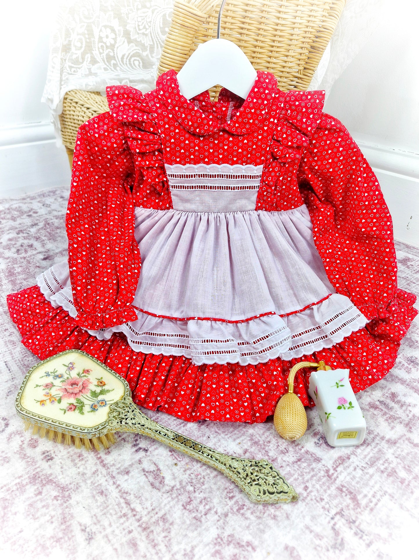 12-18 months. Red vintage dress with white heart print and faux pinny. Flutter shoulders and Peter Pan collar