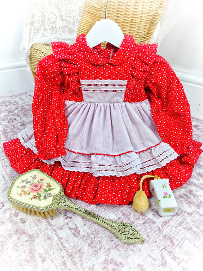 12-18 months. Red vintage dress with white heart print and faux pinny. Flutter shoulders and Peter Pan collar