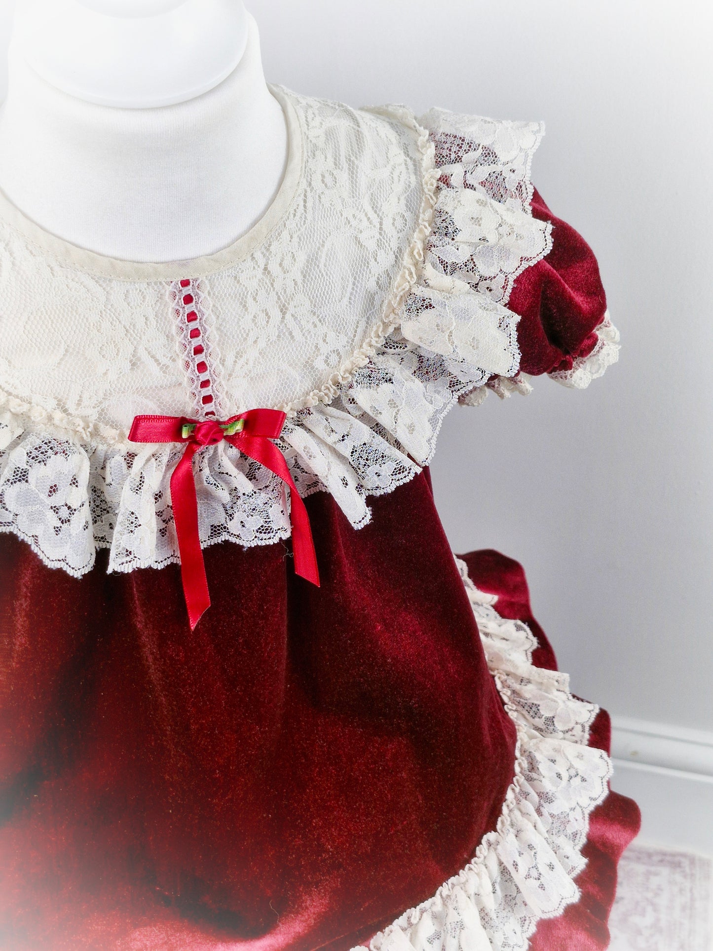 3 years. Vintage burgundy soft velvet dress with white lace bib and trim, red ribbon and rosette