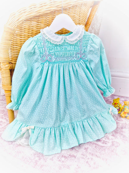 12-18 months. Mint vintage Polly Flinders smock dress with white collar and pink smocking