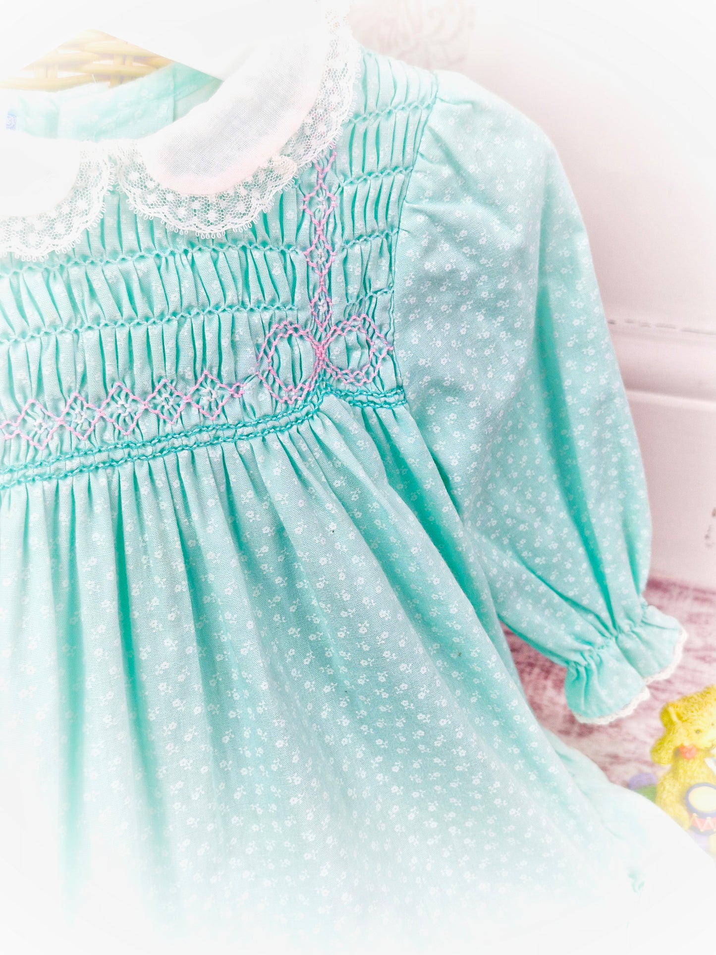 12-18 months. Mint vintage Polly Flinders smock dress with white collar and pink smocking