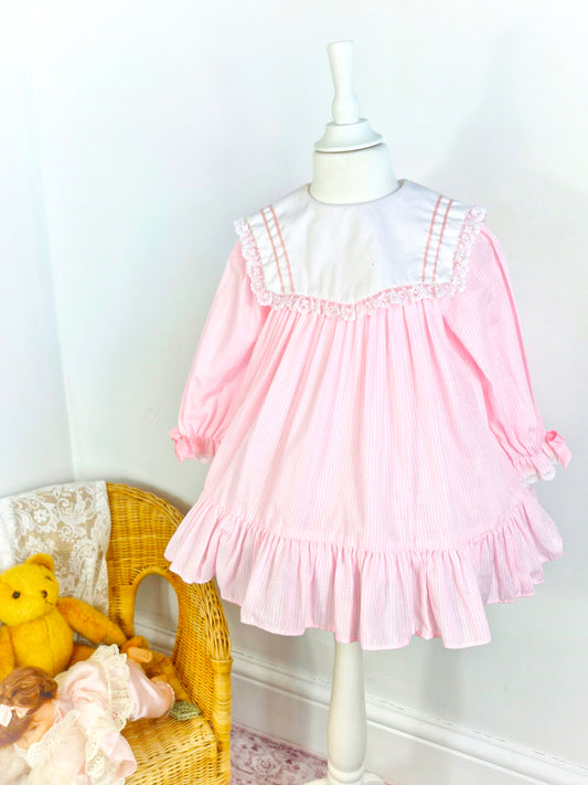 3 years. Pink and white striped vintage dress with large white bib, pink ribbon and lace trim
