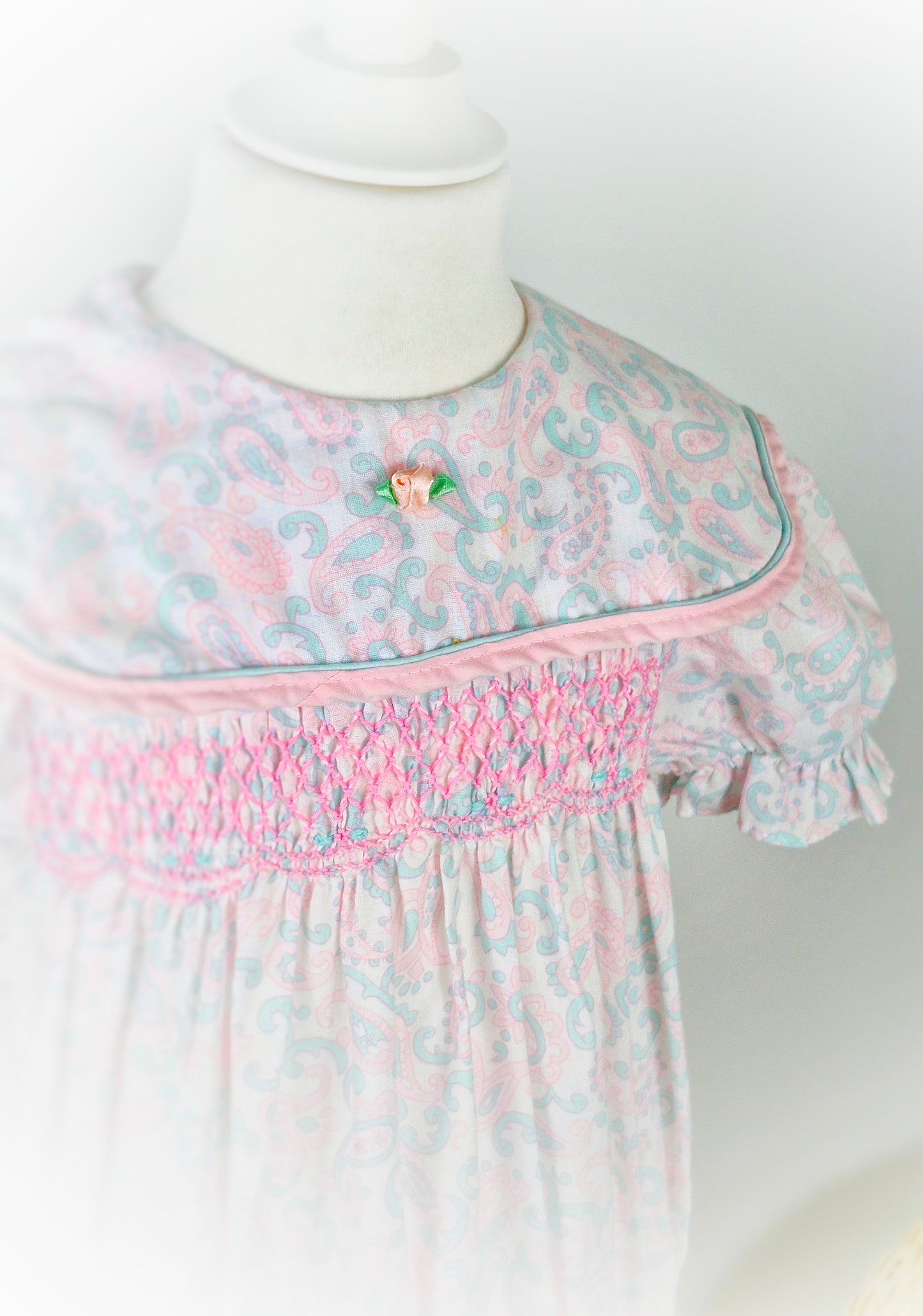 4-5 years. Vintage Polly Flinders drop waist dress with pastel Paisley patterns, pink smocking and large bow