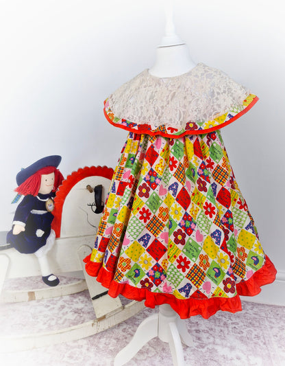 5 years. Vintage inspired patchwork style dress, sleeveless with large lace bib