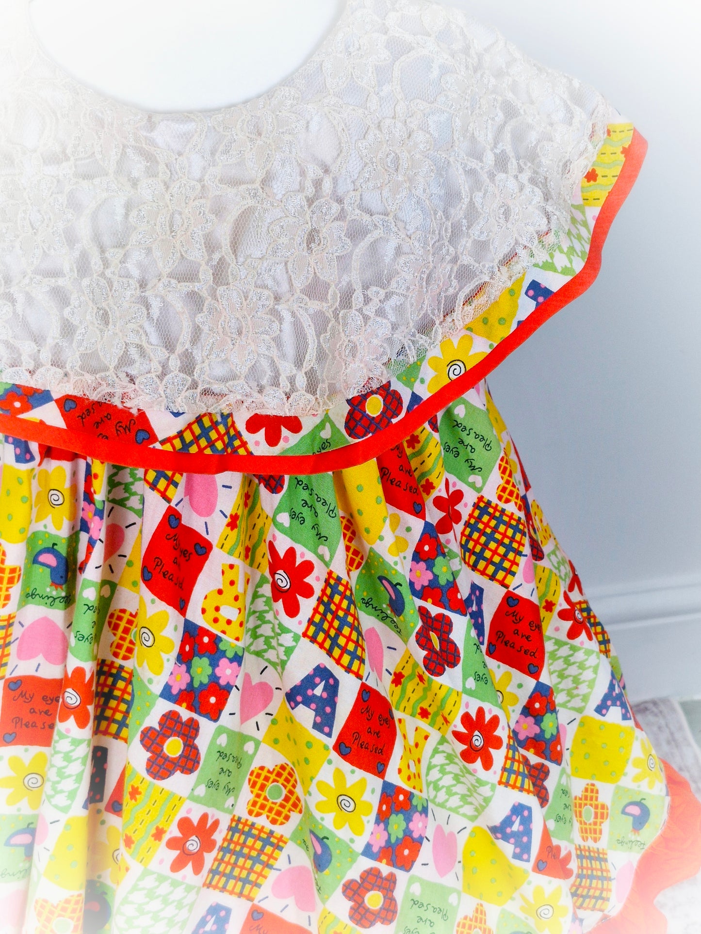 5 years. Vintage inspired patchwork style dress, sleeveless with large lace bib