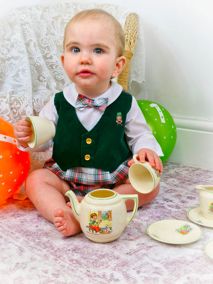 12 months. Vintage romper by Great Guy. Long sleeves, green velvet-like vest, tartan bottom and bow tie. Embroidered toy soldier and gold buttons