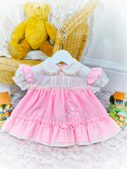 6-9 months. Pink and white vintage dress with flowers, lace and an embroidered bow