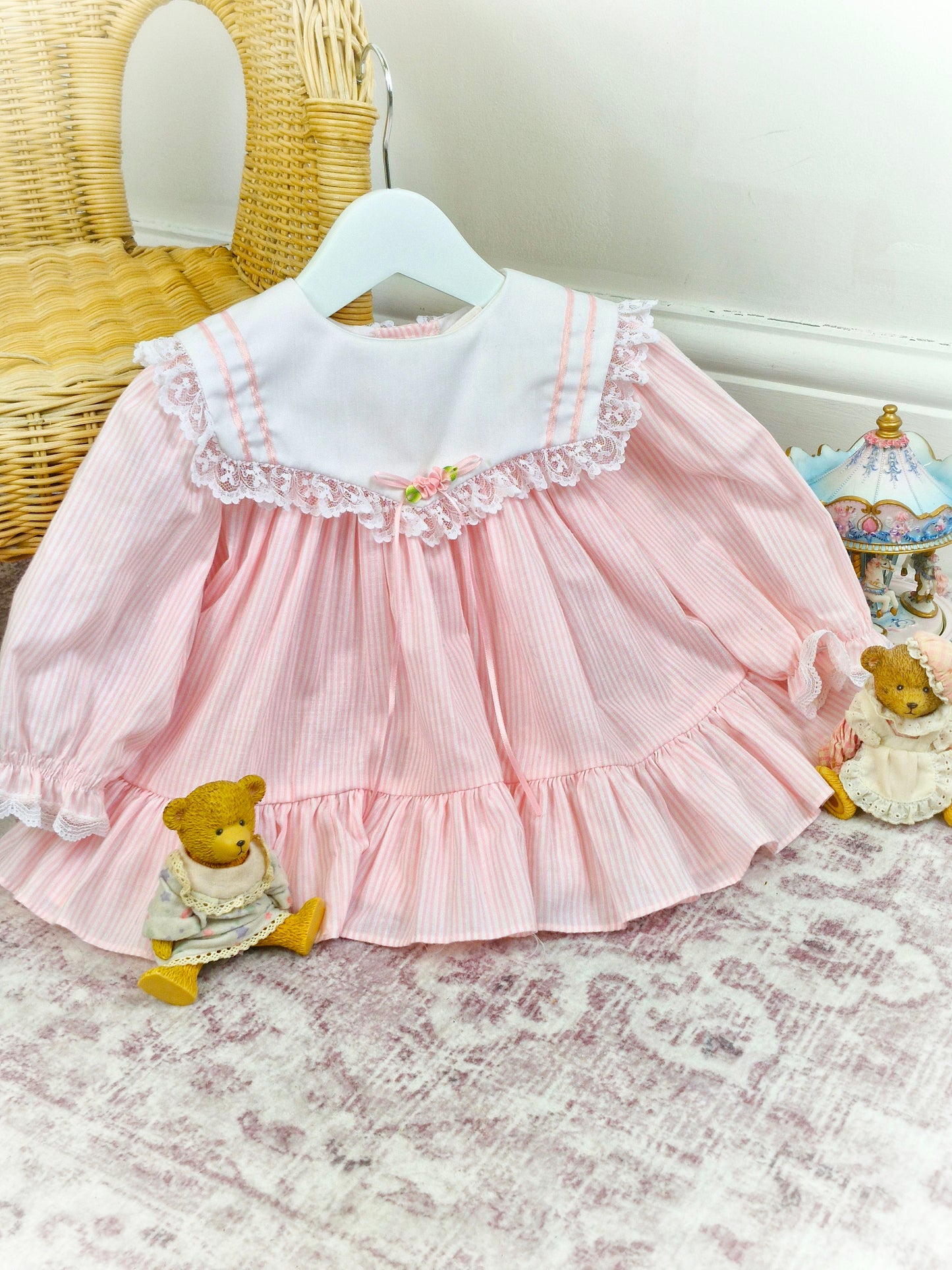 9-12 months. White and pink candy striped Bryan, white bib with lace trim, pink ribbon and rosette