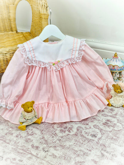 9-12 months. White and pink candy striped Bryan, white bib with lace trim, pink ribbon and rosette