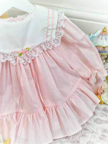 9-12 months. White and pink candy striped Bryan, white bib with lace trim, pink ribbon and rosette