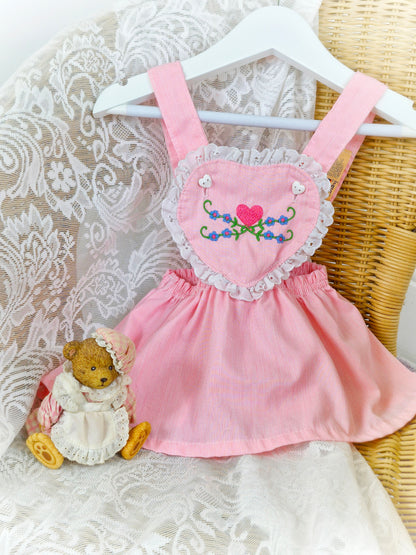 9-12 months. Pink vintage Carter's pinafore dress with embroidered heart shaped bib and lace trim