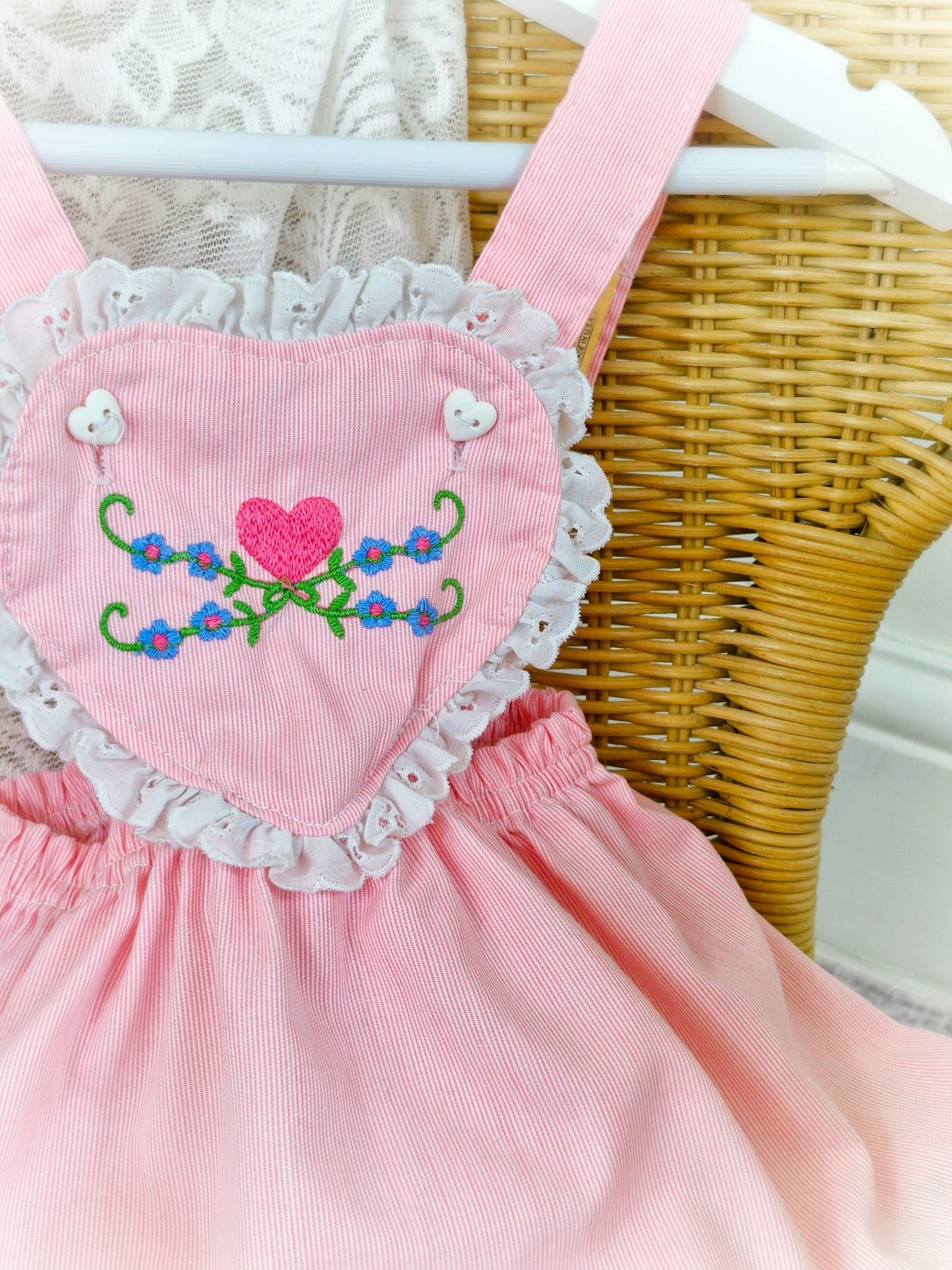 9-12 months. Pink vintage Carter's pinafore dress with embroidered heart shaped bib and lace trim