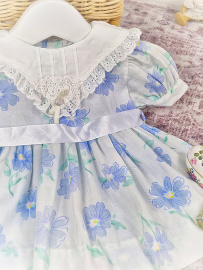 6-9 months. White vintage dress with blue floral patterns, white bib and satin ribbon