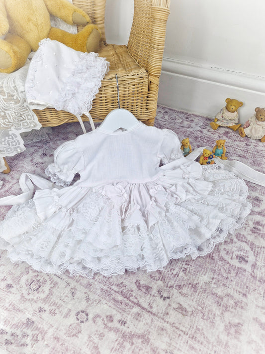 6-12 months. All white Lid'l Dolly, lots of lace ruffles. Free bonnet*