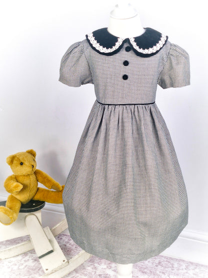 6 years. Black and white gingham dress from Bonnie Baby with black velour collar and buttons
