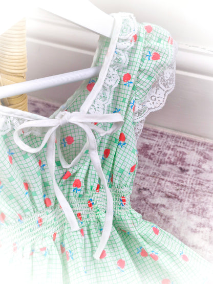 2 years. Green and white checked vintage dress with smocking, apple print and lace trim